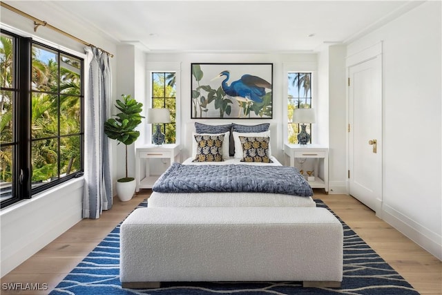 bedroom with light wood-style flooring and baseboards