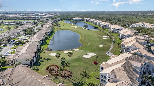 aerial view featuring golf course view, a water view, and a residential view