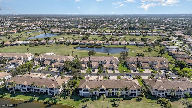 birds eye view of property featuring golf course view, a water view, and a residential view