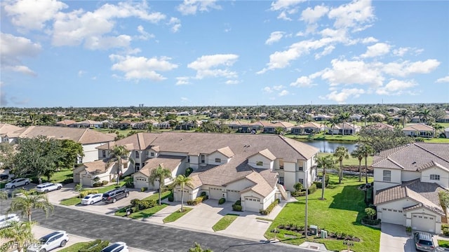 birds eye view of property featuring a water view and a residential view