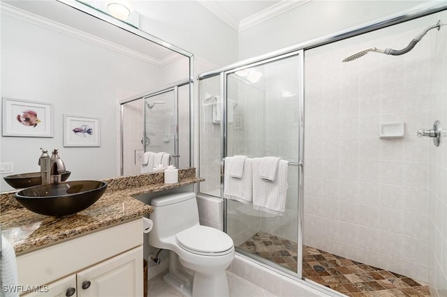 full bathroom with toilet, ornamental molding, a stall shower, and vanity