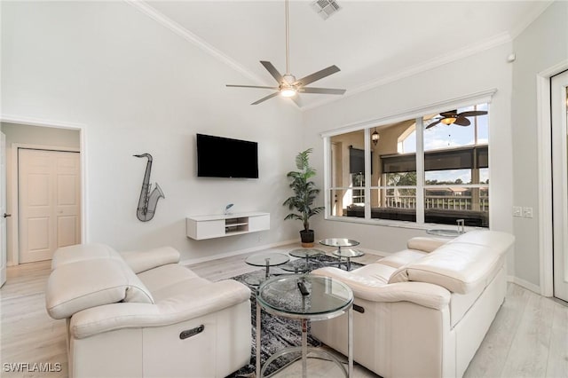 living room featuring crown molding, visible vents, ceiling fan, wood finished floors, and baseboards