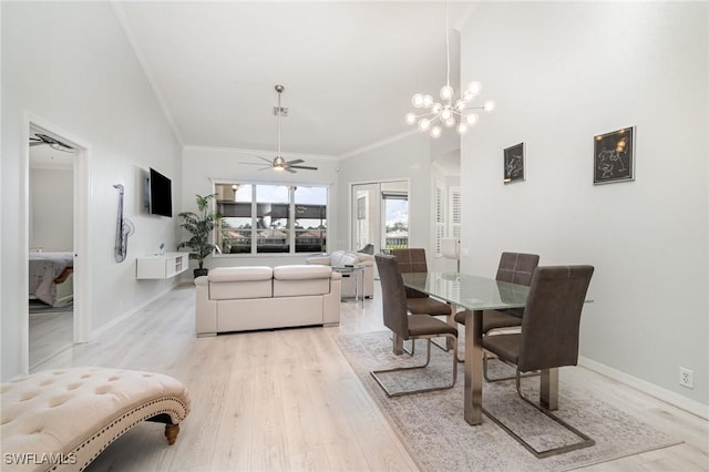 dining space featuring baseboards, a high ceiling, crown molding, light wood-style floors, and ceiling fan with notable chandelier