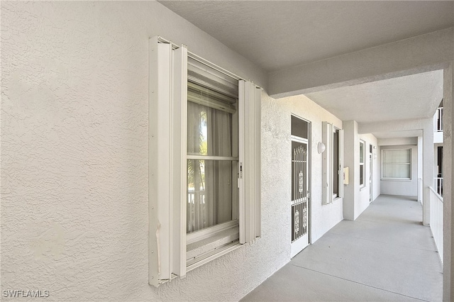 entrance to property featuring stucco siding