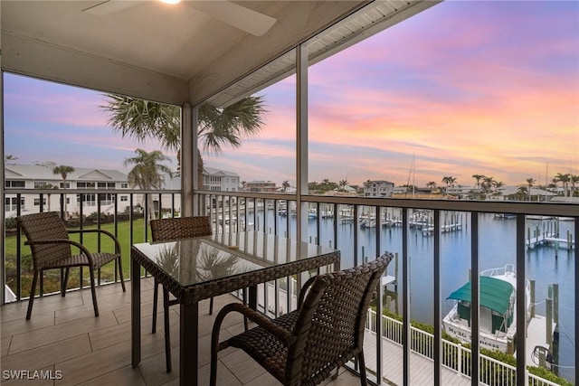 balcony featuring a ceiling fan and a water view