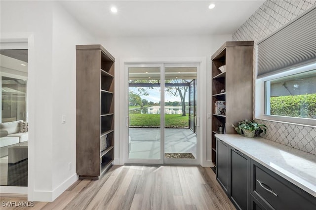 entryway featuring light wood finished floors, plenty of natural light, and recessed lighting