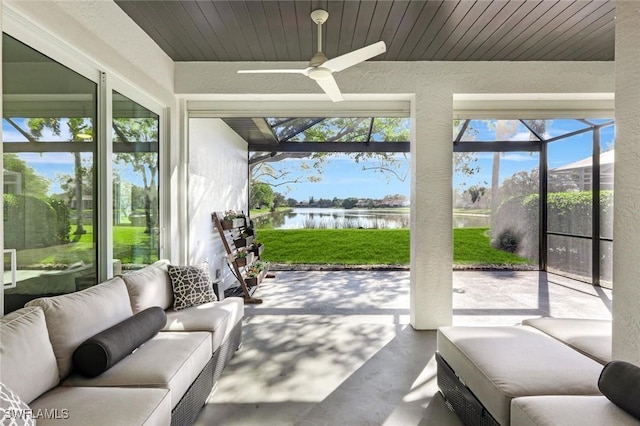 sunroom featuring a water view, ceiling fan, plenty of natural light, and an outdoor hangout area