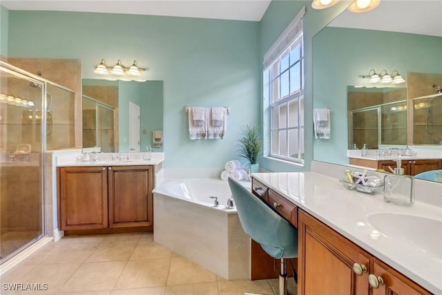 full bath with a sink, a garden tub, a shower stall, and tile patterned flooring