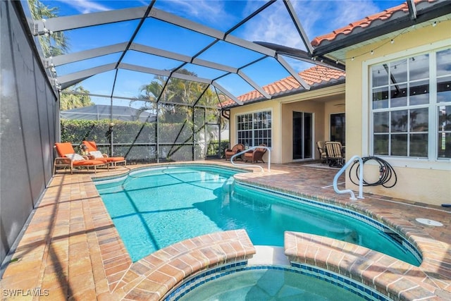 view of pool featuring a patio and a pool with connected hot tub