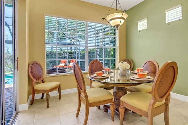 dining area featuring light tile patterned flooring and baseboards