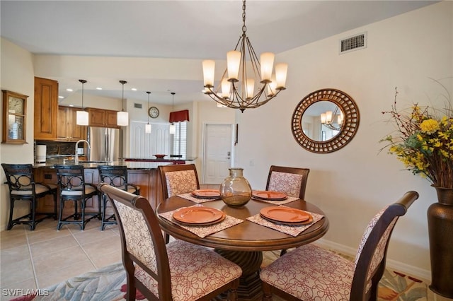 dining area with a notable chandelier, light tile patterned floors, recessed lighting, visible vents, and baseboards