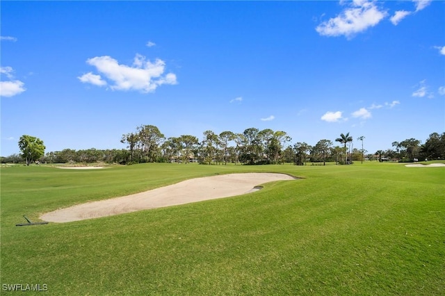 view of home's community featuring a yard and golf course view