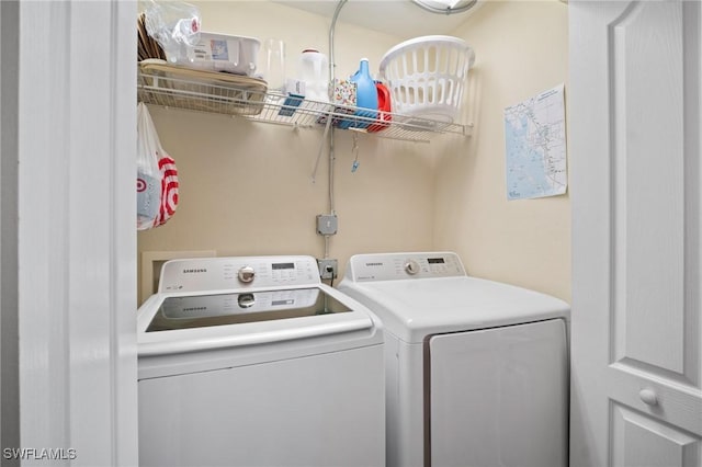 washroom featuring laundry area and washing machine and dryer