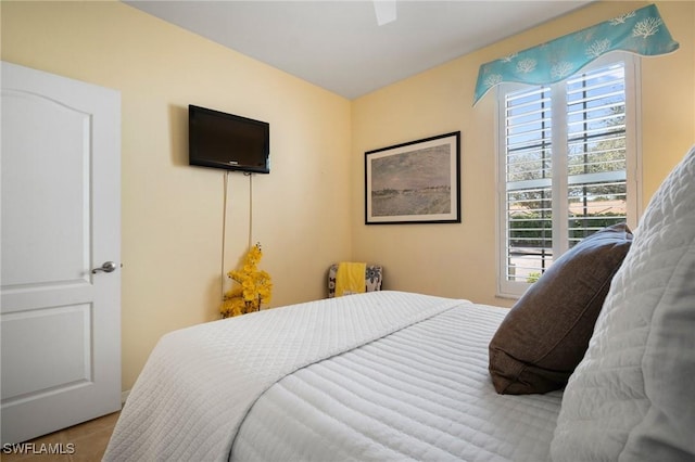 bedroom featuring multiple windows and a ceiling fan