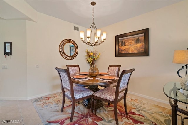 dining room with light tile patterned floors, baseboards, visible vents, and a notable chandelier