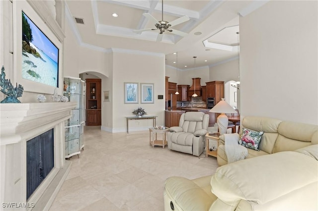 living room featuring visible vents, coffered ceiling, arched walkways, a fireplace, and a towering ceiling