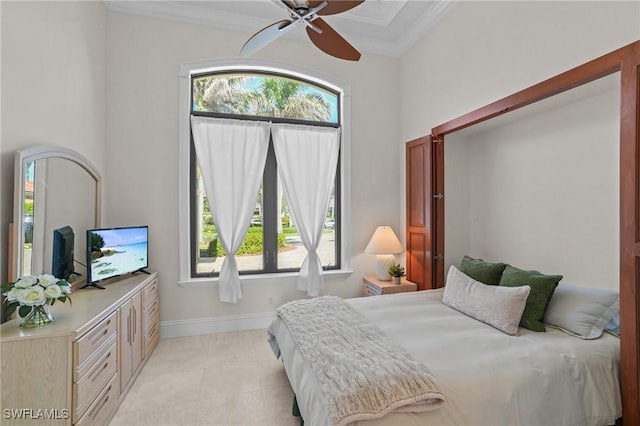 bedroom featuring light tile patterned floors, crown molding, and baseboards