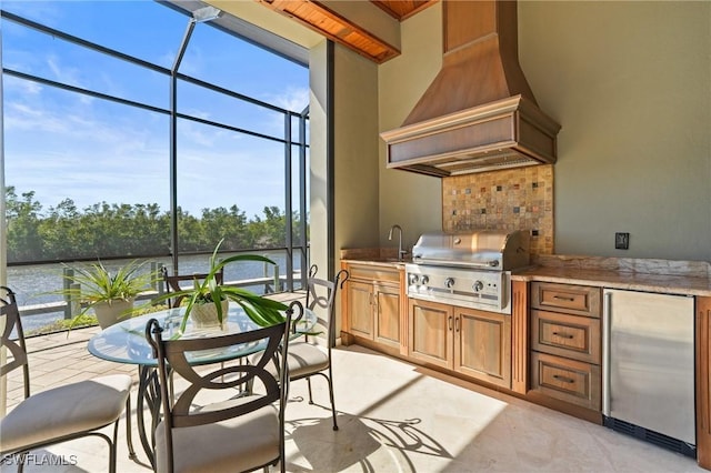 interior space featuring grilling area, glass enclosure, a water view, and area for grilling