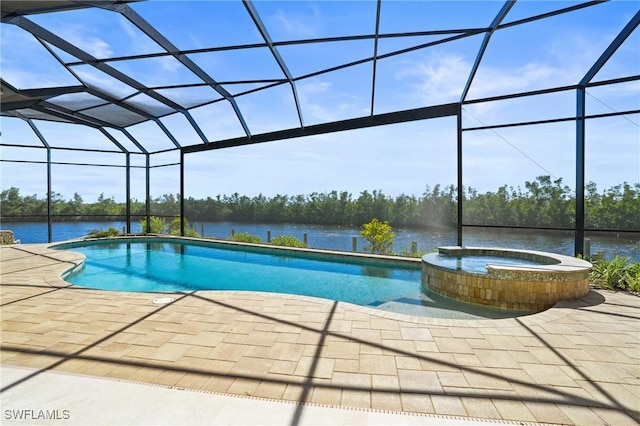 view of pool with a patio area, a pool with connected hot tub, a lanai, and a water view