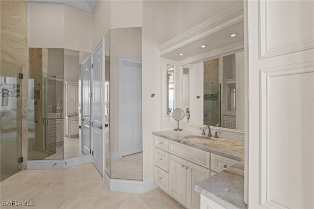 bathroom featuring tile patterned floors, a stall shower, and vanity