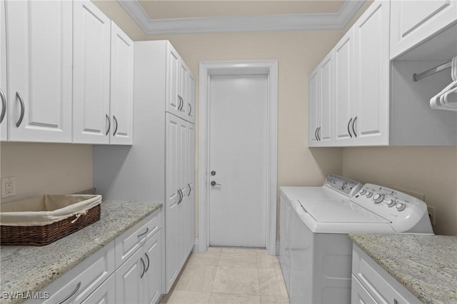 laundry room with crown molding, cabinet space, and washing machine and clothes dryer