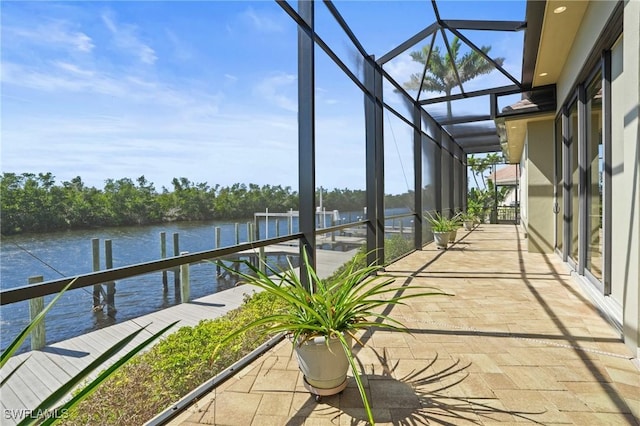 unfurnished sunroom featuring a water view