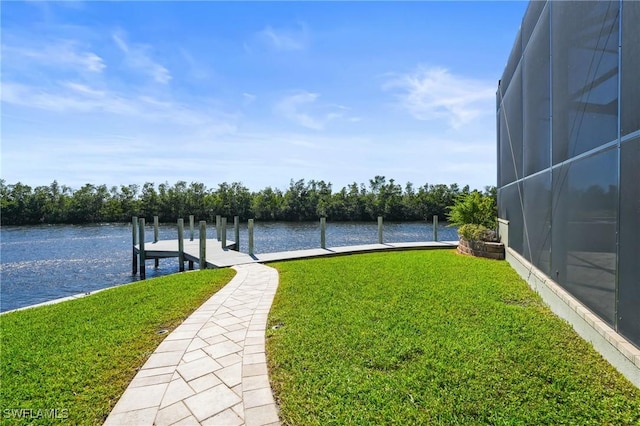 view of yard featuring a water view, a lanai, and a dock