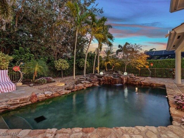 view of swimming pool featuring fence, a fenced in pool, and a patio