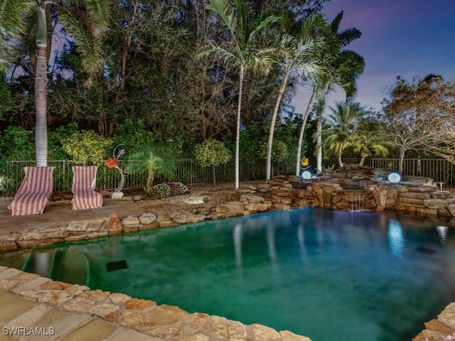 view of swimming pool with fence and a patio