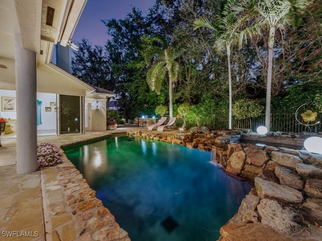 view of swimming pool with a patio area, fence, and a fenced in pool