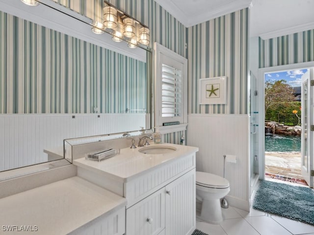 bathroom with a wainscoted wall, a water view, toilet, and wallpapered walls