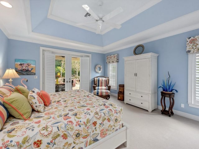 bedroom featuring access to exterior, a tray ceiling, french doors, light carpet, and baseboards