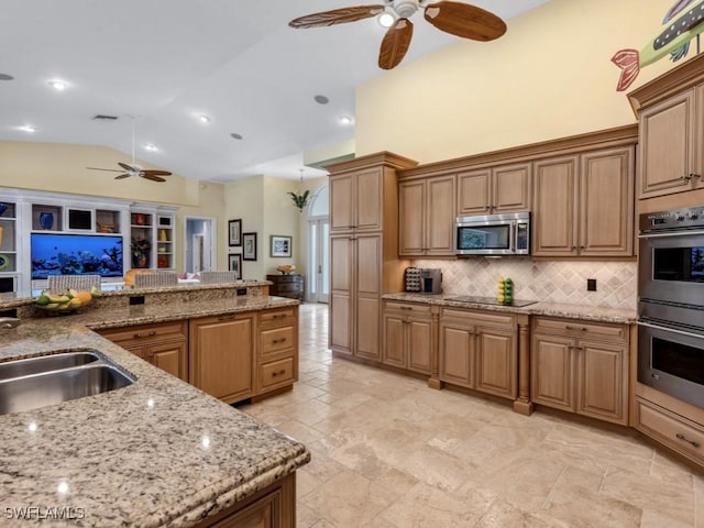 kitchen with light stone countertops, stainless steel appliances, visible vents, brown cabinets, and tasteful backsplash