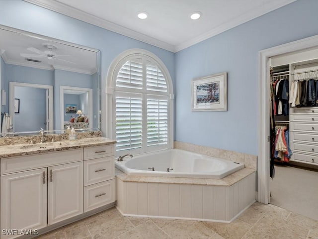 full bath featuring a garden tub, crown molding, vanity, and a spacious closet