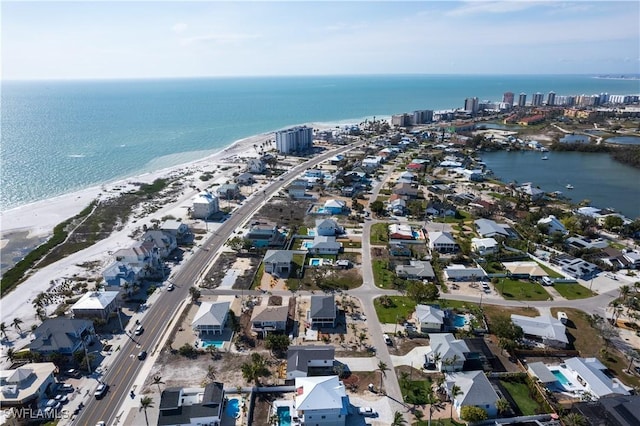 drone / aerial view with a water view, a view of city, and a view of the beach