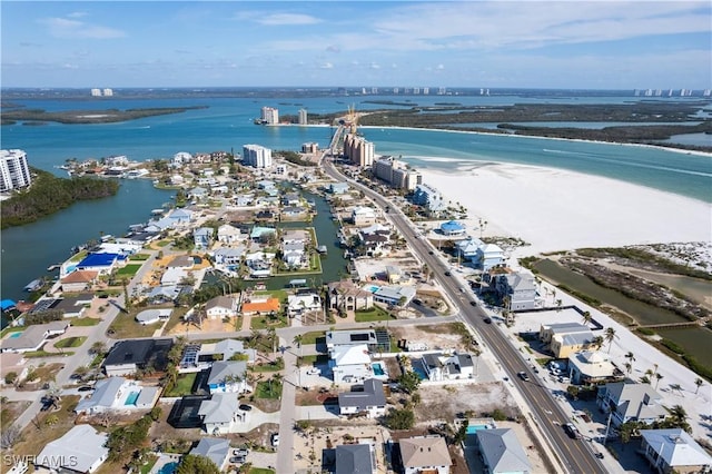 bird's eye view featuring a water view and a beach view