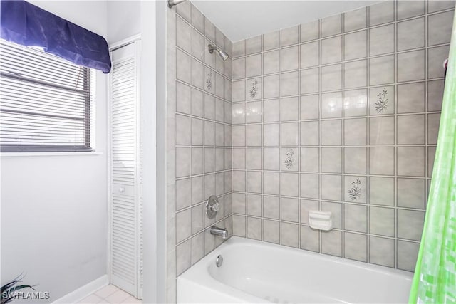 bathroom with shower / tub combo, a closet, and baseboards