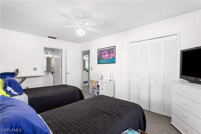 carpeted bedroom featuring a ceiling fan, a closet, and visible vents