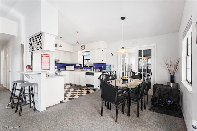 dining area featuring dark colored carpet