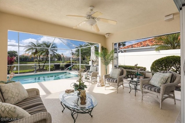 sunroom / solarium with a ceiling fan and a wealth of natural light