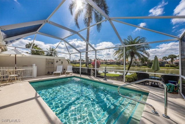 outdoor pool featuring a patio and glass enclosure