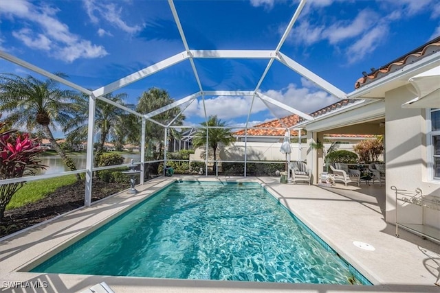 view of swimming pool with a fenced in pool, glass enclosure, and a patio