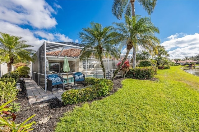 view of yard featuring a lanai, a patio area, and an outdoor pool