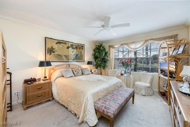 carpeted bedroom featuring baseboards, ornamental molding, and a ceiling fan