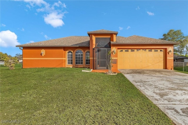 view of front of home with a front yard, driveway, an attached garage, and stucco siding