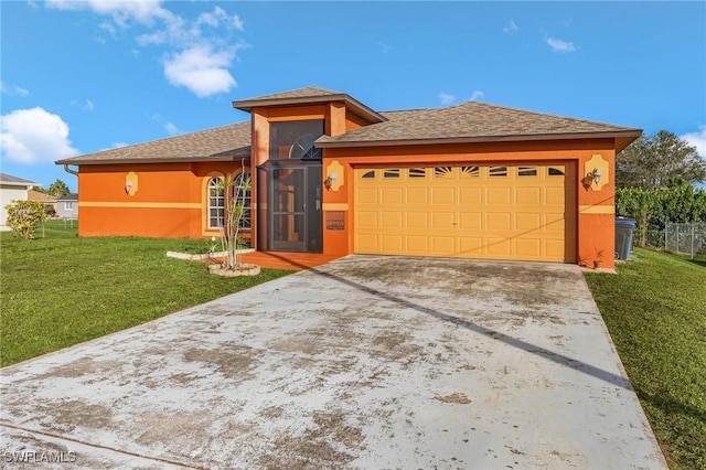 view of front of house with a garage, concrete driveway, a front lawn, and stucco siding