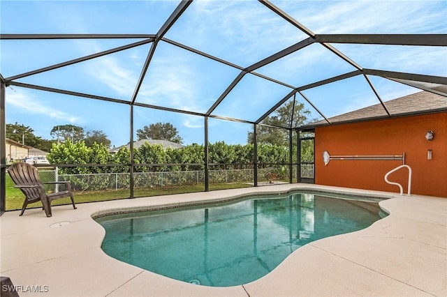 pool featuring a patio area and glass enclosure