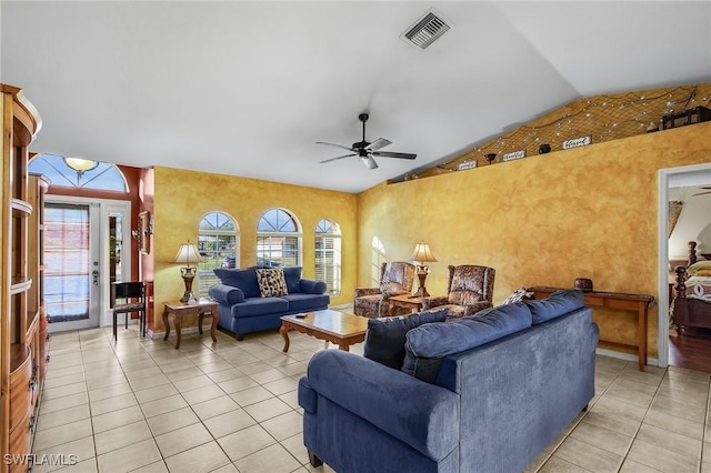 living room with light tile patterned floors, vaulted ceiling, visible vents, and a ceiling fan