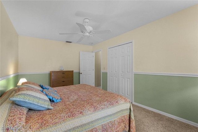 carpeted bedroom with a ceiling fan, a closet, and baseboards