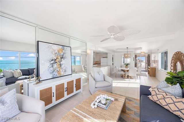 living room with ceiling fan and light tile patterned flooring